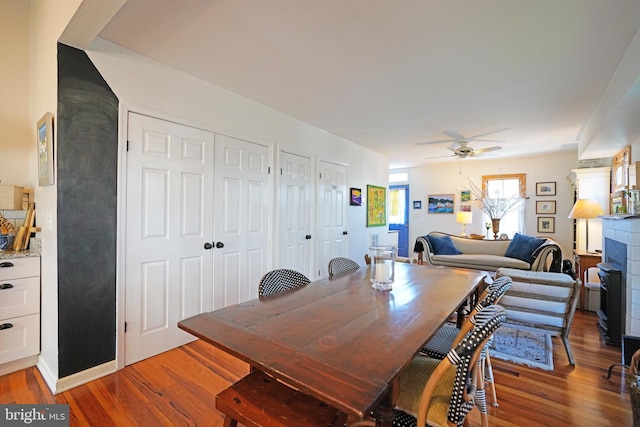 dining room featuring light wood-style flooring and a ceiling fan