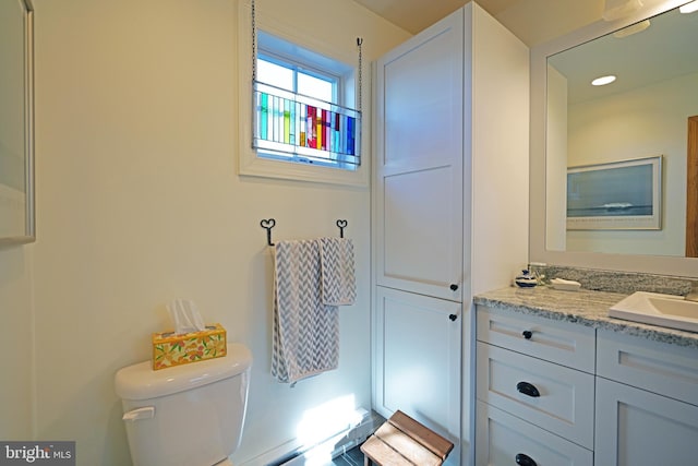 bathroom featuring toilet and vanity