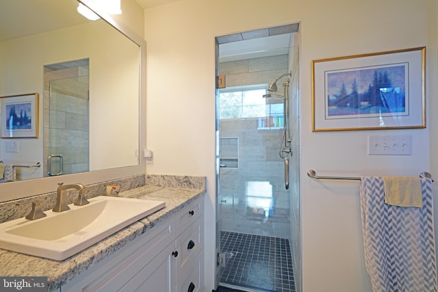 full bathroom featuring a shower stall and vanity