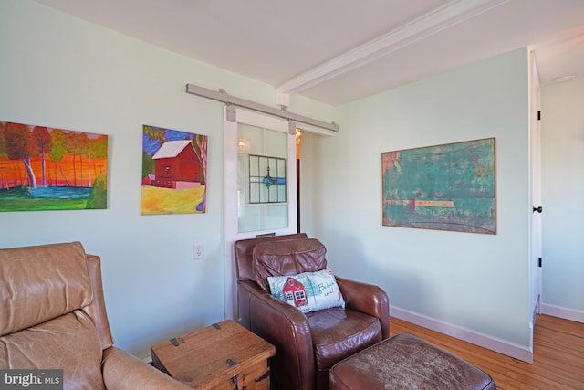 sitting room with baseboards and wood finished floors