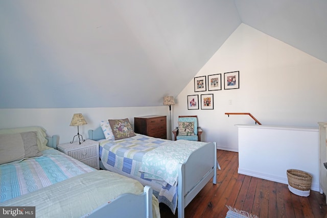 bedroom with lofted ceiling and hardwood / wood-style flooring