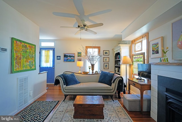 sitting room featuring plenty of natural light, visible vents, and wood finished floors