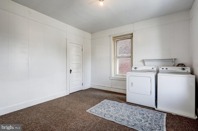 laundry area featuring laundry area, dark carpet, washing machine and dryer, and baseboards