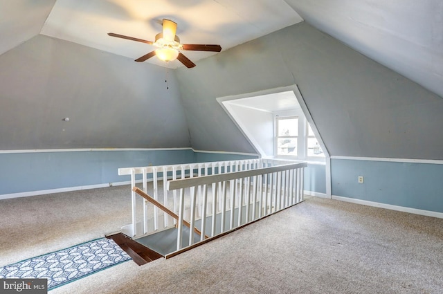 bonus room with lofted ceiling, carpet flooring, and baseboards