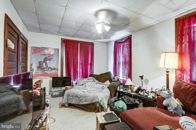 bedroom with a paneled ceiling and carpet