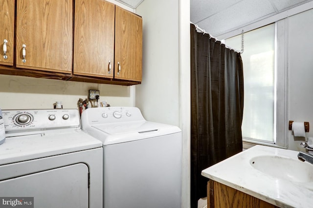 laundry area with laundry area, a sink, and washer and dryer