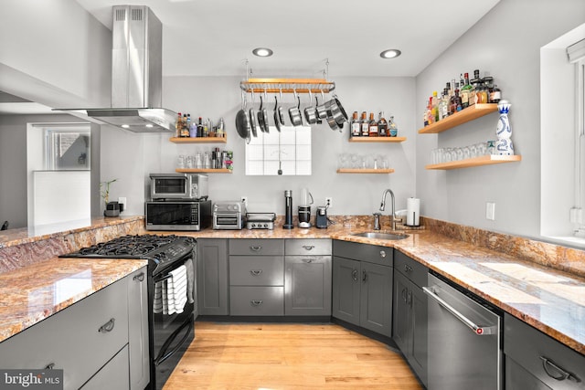 kitchen featuring gas stove, open shelves, gray cabinets, a sink, and dishwasher