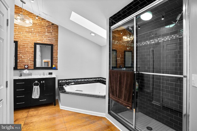 bathroom with a garden tub, vanity, and a shower stall