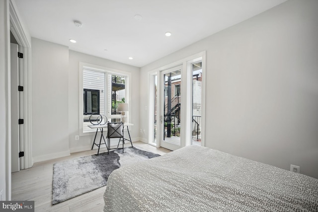 bedroom featuring access to exterior, baseboards, wood finished floors, and recessed lighting