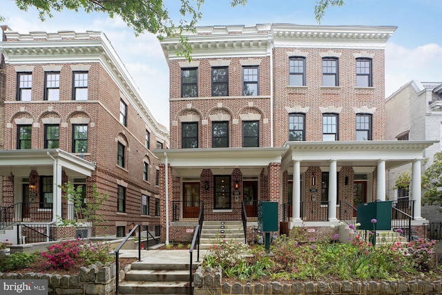 townhome / multi-family property featuring brick siding