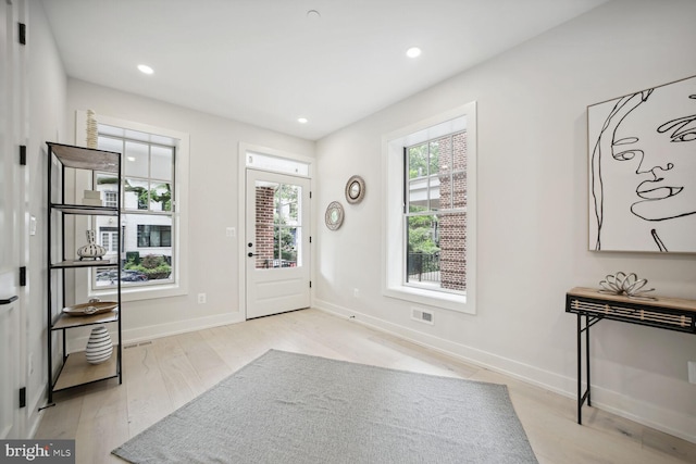 entrance foyer featuring light wood-style floors, recessed lighting, and baseboards