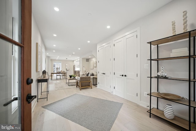 foyer entrance with light wood finished floors and recessed lighting