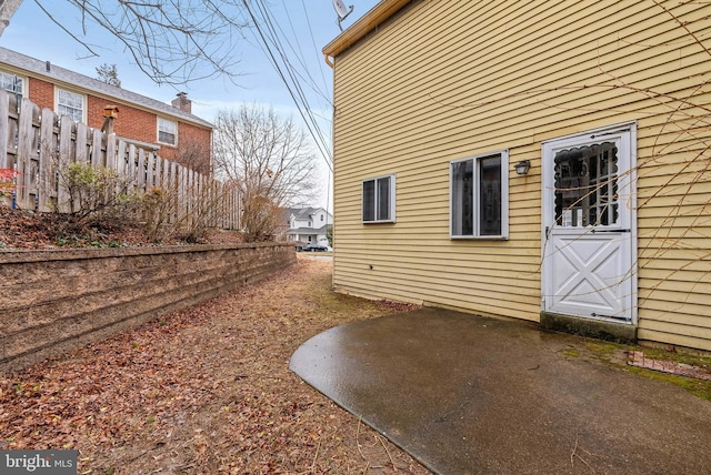 view of home's exterior featuring fence and a patio