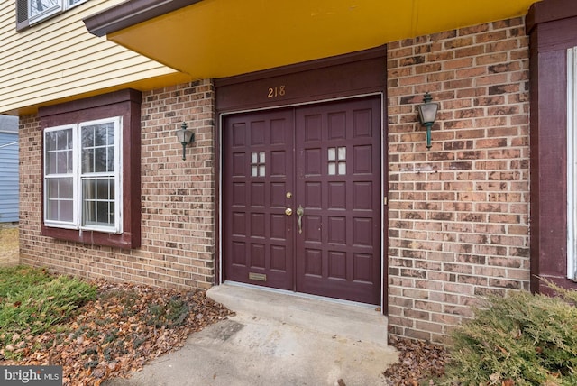 entrance to property with brick siding