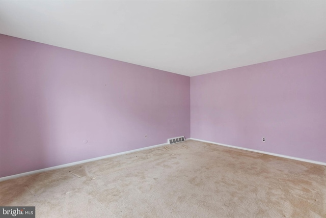 carpeted empty room with baseboards and visible vents