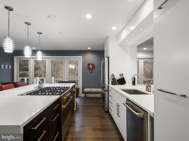 kitchen featuring white cabinets, stainless steel appliances, modern cabinets, and a sink