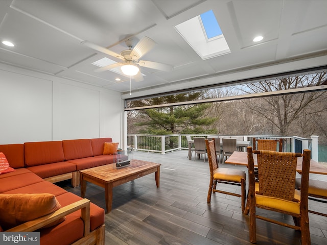 sunroom with a skylight and a ceiling fan