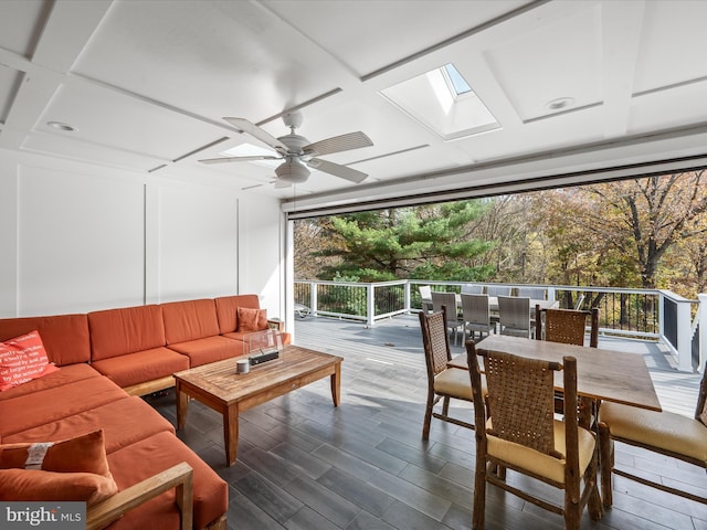 sunroom featuring a skylight, coffered ceiling, and ceiling fan