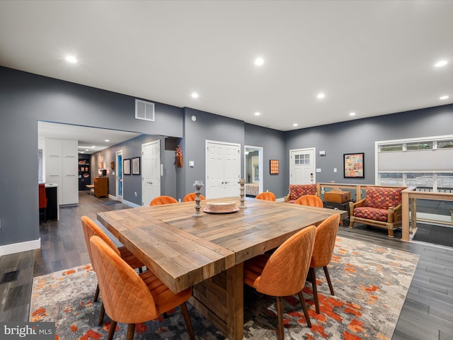 dining area featuring wood finished floors, recessed lighting, visible vents, and baseboards