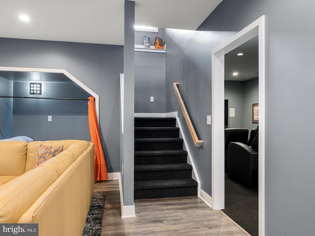 stairway featuring recessed lighting, baseboards, and wood finished floors