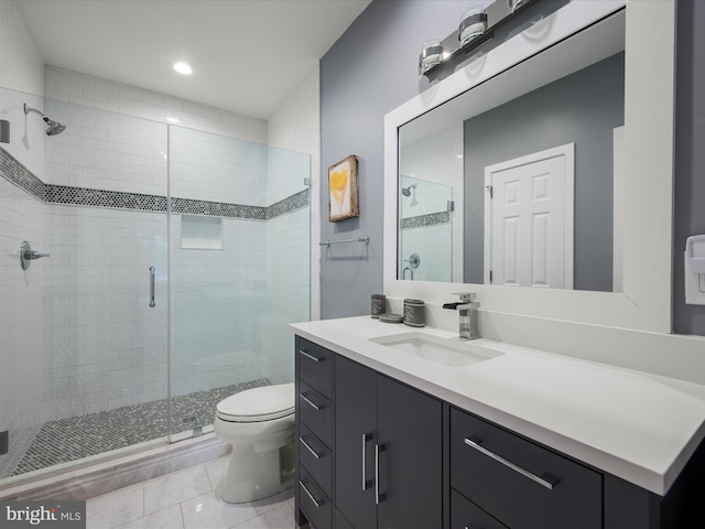 full bath with tile patterned floors, a shower stall, toilet, and vanity