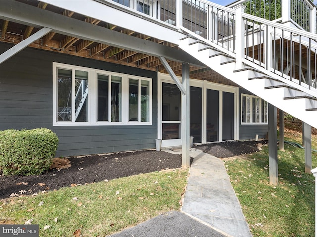 view of property exterior with stairs and a sunroom