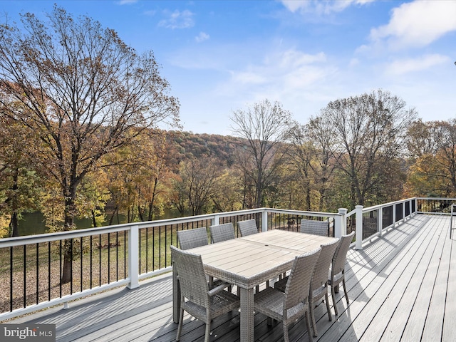 wooden terrace featuring outdoor dining area