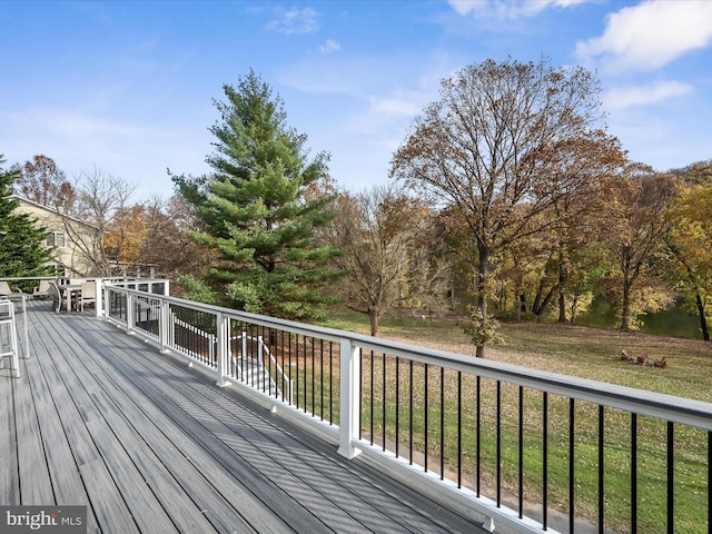 wooden terrace with a lawn