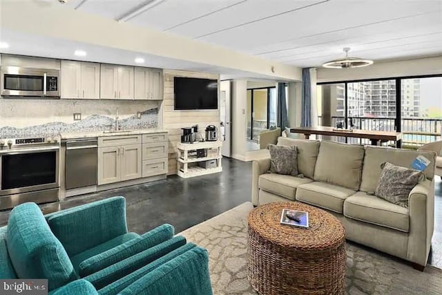 living room with recessed lighting and finished concrete flooring