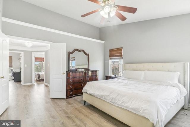 bedroom featuring ceiling fan, baseboards, vaulted ceiling, and wood finished floors