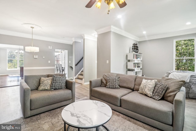 living room with ornamental molding, recessed lighting, light wood-style floors, and baseboards