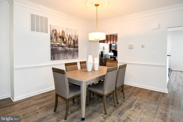 dining room with baseboards, crown molding, visible vents, and dark wood-style flooring