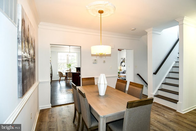 dining room featuring stairs, ornamental molding, and dark wood finished floors