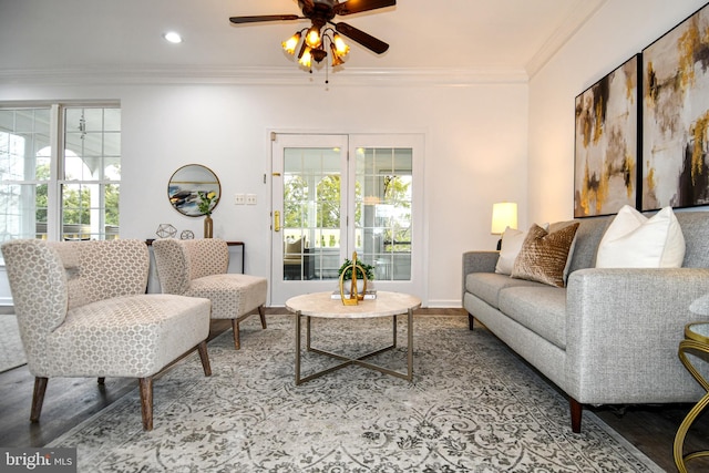 living area with ornamental molding, plenty of natural light, and wood finished floors