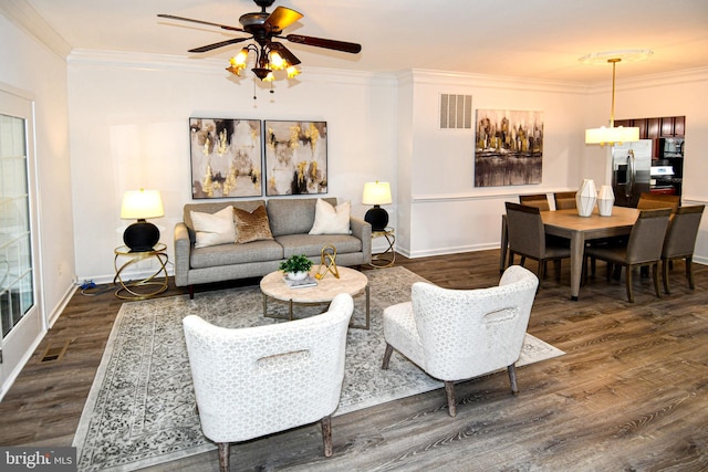 living area featuring baseboards, crown molding, visible vents, and dark wood-style flooring