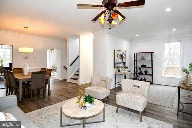 living room with stairway, crown molding, and wood finished floors