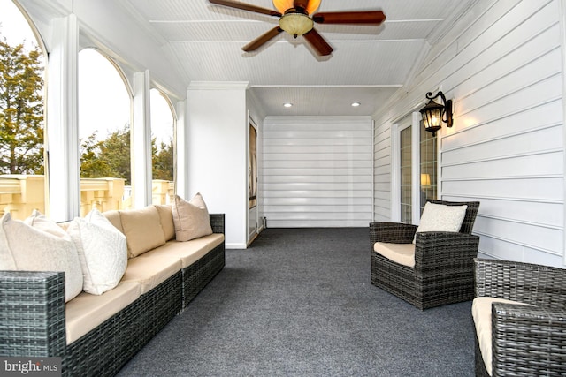 sunroom / solarium featuring lofted ceiling and ceiling fan