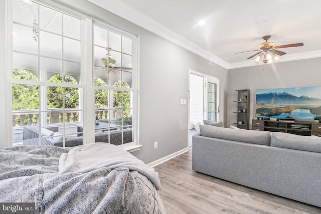 living area with ceiling fan, ornamental molding, wood finished floors, and baseboards