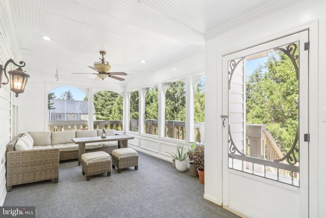 sunroom / solarium with a ceiling fan