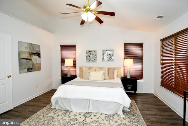 bedroom with lofted ceiling, dark wood-style floors, baseboards, and visible vents