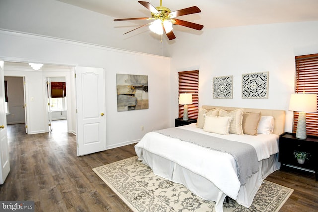 bedroom featuring lofted ceiling, dark wood-style floors, ceiling fan, and baseboards