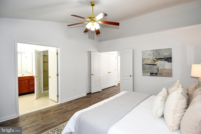 bedroom featuring a ceiling fan, visible vents, vaulted ceiling, light wood-style floors, and ensuite bath