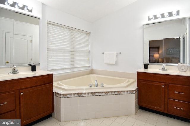 full bathroom featuring tile patterned flooring, two vanities, a sink, and a bath