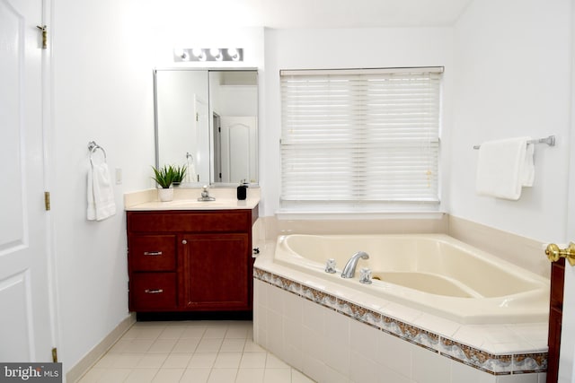 bathroom with tile patterned flooring, a bath, and vanity