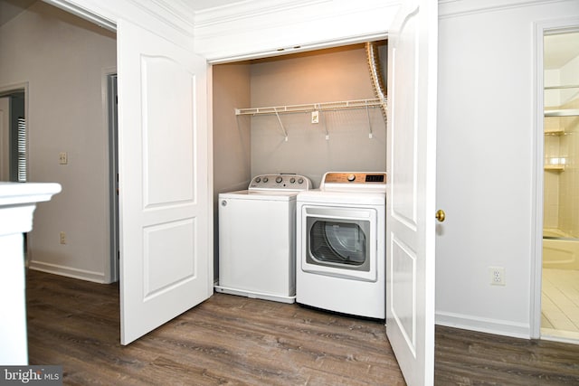 laundry room featuring dark wood-style floors, laundry area, crown molding, and washer and clothes dryer