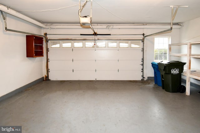 garage with baseboards and a garage door opener