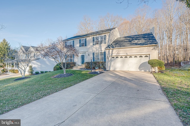 view of front of house featuring a garage, driveway, a chimney, and a front yard