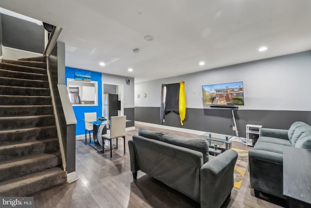 living room featuring recessed lighting, stairway, baseboards, and wood finished floors