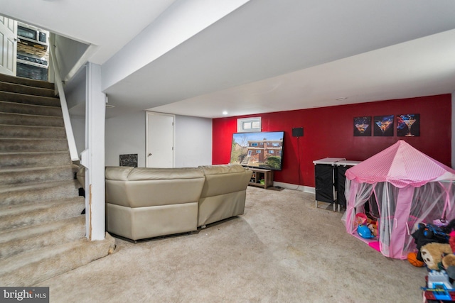 living area with carpet flooring, stairway, and baseboards