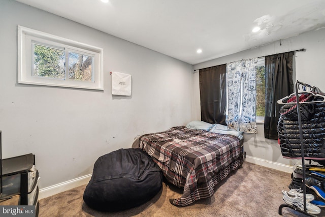 carpeted bedroom featuring recessed lighting and baseboards